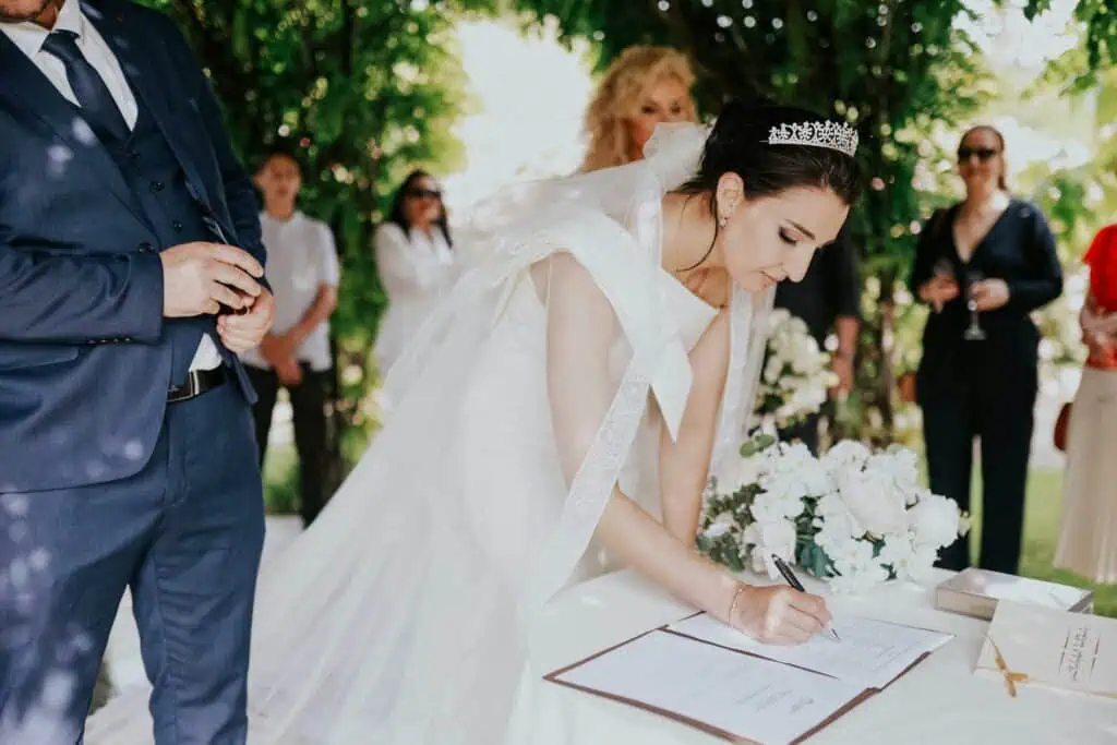 A Bride Signing the Marriage Certificate in the Garden