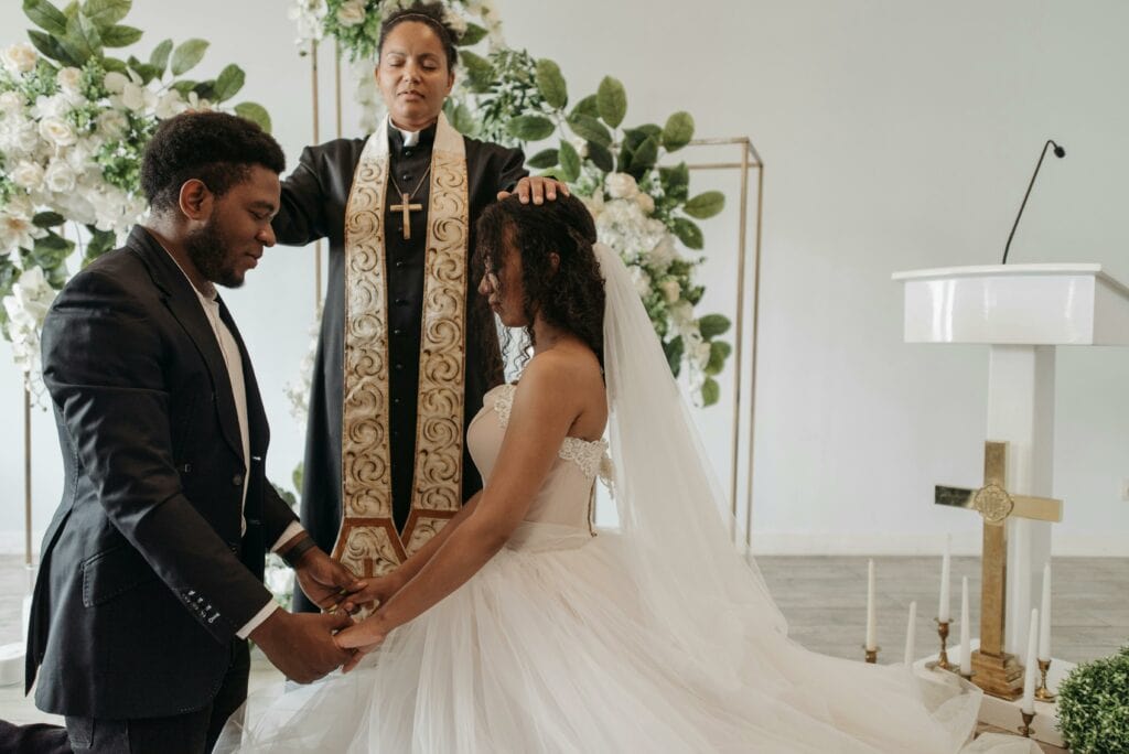 Bride and groom receiving blessings in a beautifully decorated wedding ceremony.